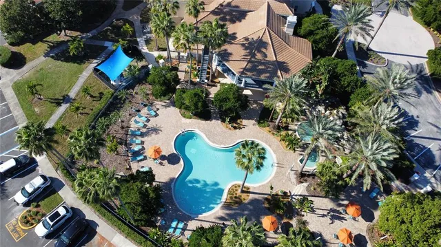 an aerial view of a house with a yard and swimming pool