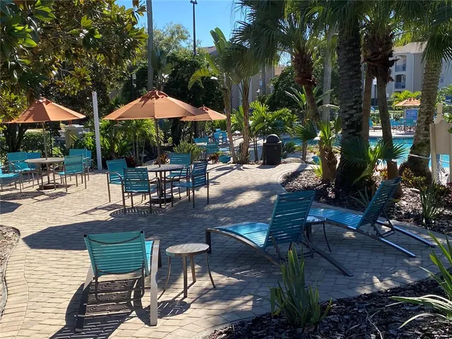 an aerial view of a house with a yard and outdoor seating