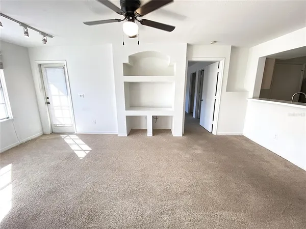 a view of empty room with a fireplace and cabinet