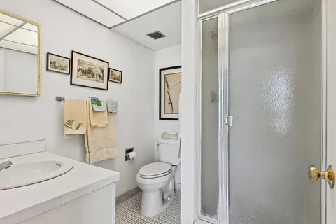 a white toilet sitting next to a bathroom sink