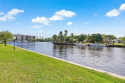 a view of a lake with houses in the back