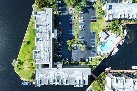 a aerial view of multi story residential apartment building with yard