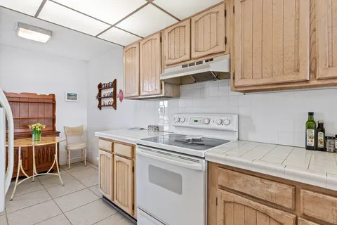 a kitchen with stainless steel appliances granite countertop a sink and cabinets