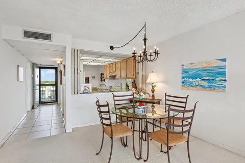a view of a dining room with furniture and chandelier