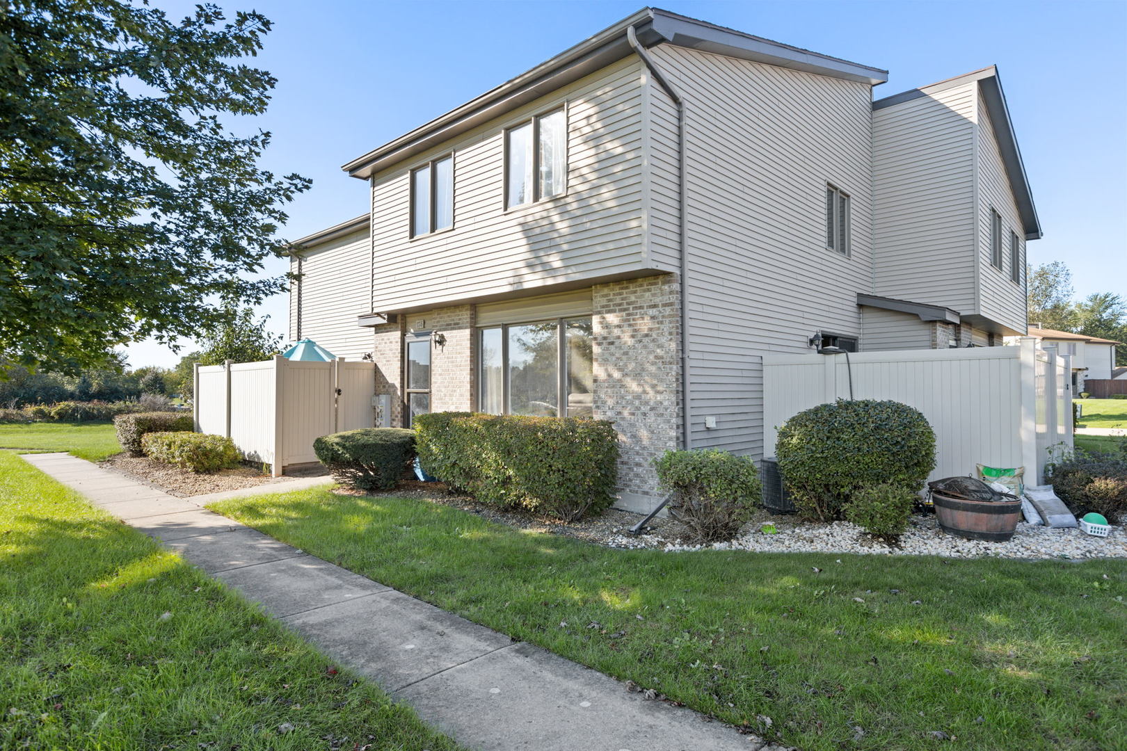 778 Lake Road, Unit 778 New Lenox, IL 60451 - Photo 1 of 16 a front view of a house with a yard and garage