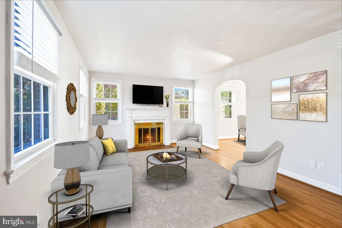 2806 Ivydale Street Silver Spring, MD 20902 - Photo 3 of 29 a living room with furniture a fireplace and a flat screen tv