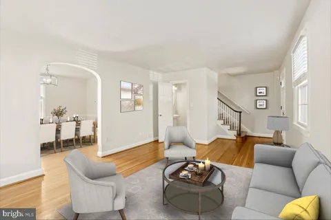 a living room with furniture or couch and a wooden floor