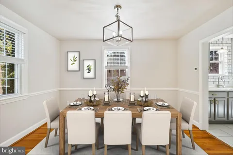 a dining room with furniture a chandelier and window