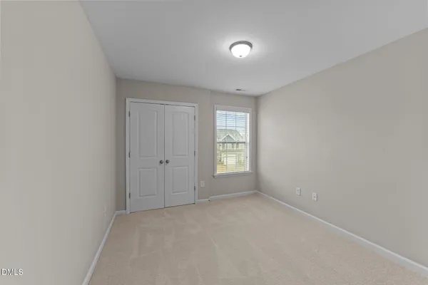 a view of an empty room and closet