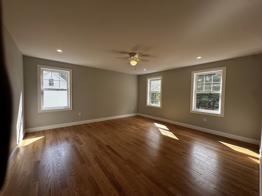 56 Dudley Road Billerica, MA 01821 - Photo 17 of 29 a view of an empty room with wooden floor and a window