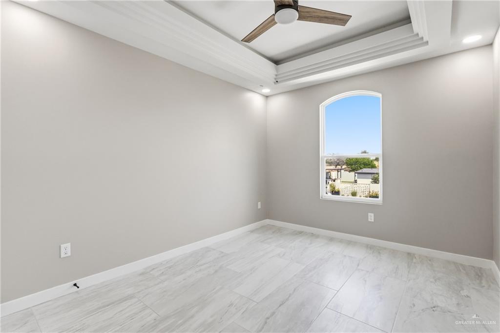 2206 Corales Street Mission, TX 78573 - Photo 16 of 19 an empty room with windows and ceiling fan
