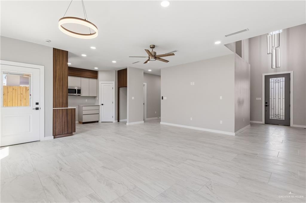 2206 Corales Street Mission, TX 78573 - Photo 3 of 19 an open kitchen with a refrigerator and a stove top oven