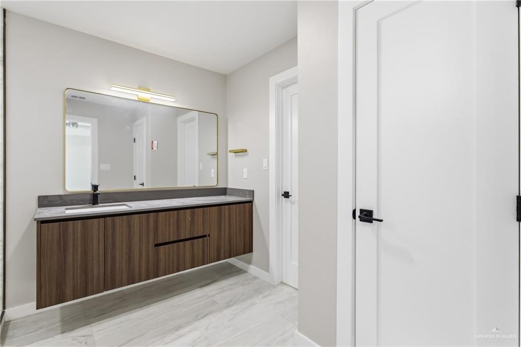 2206 Corales Street Mission, TX 78573 - Photo 9 of 19 a bathroom with a sink and a mirror