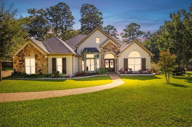 a view of a house with swimming pool and a yard