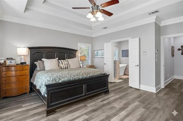 a bed room with a bed and a painting on the wall