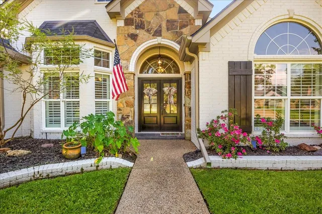 a front view of a house with a garden