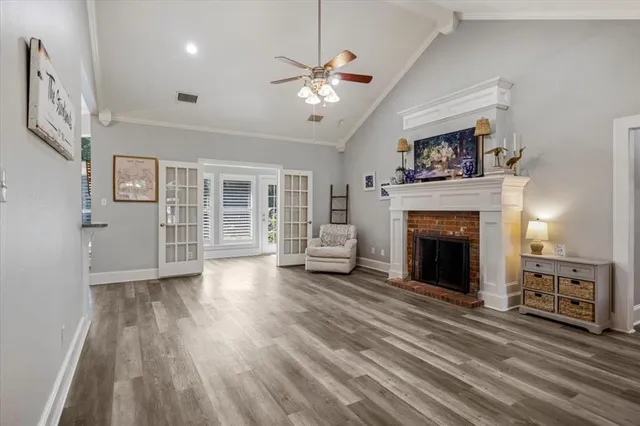 a view of a livingroom with hardwood floor and a ceiling fan