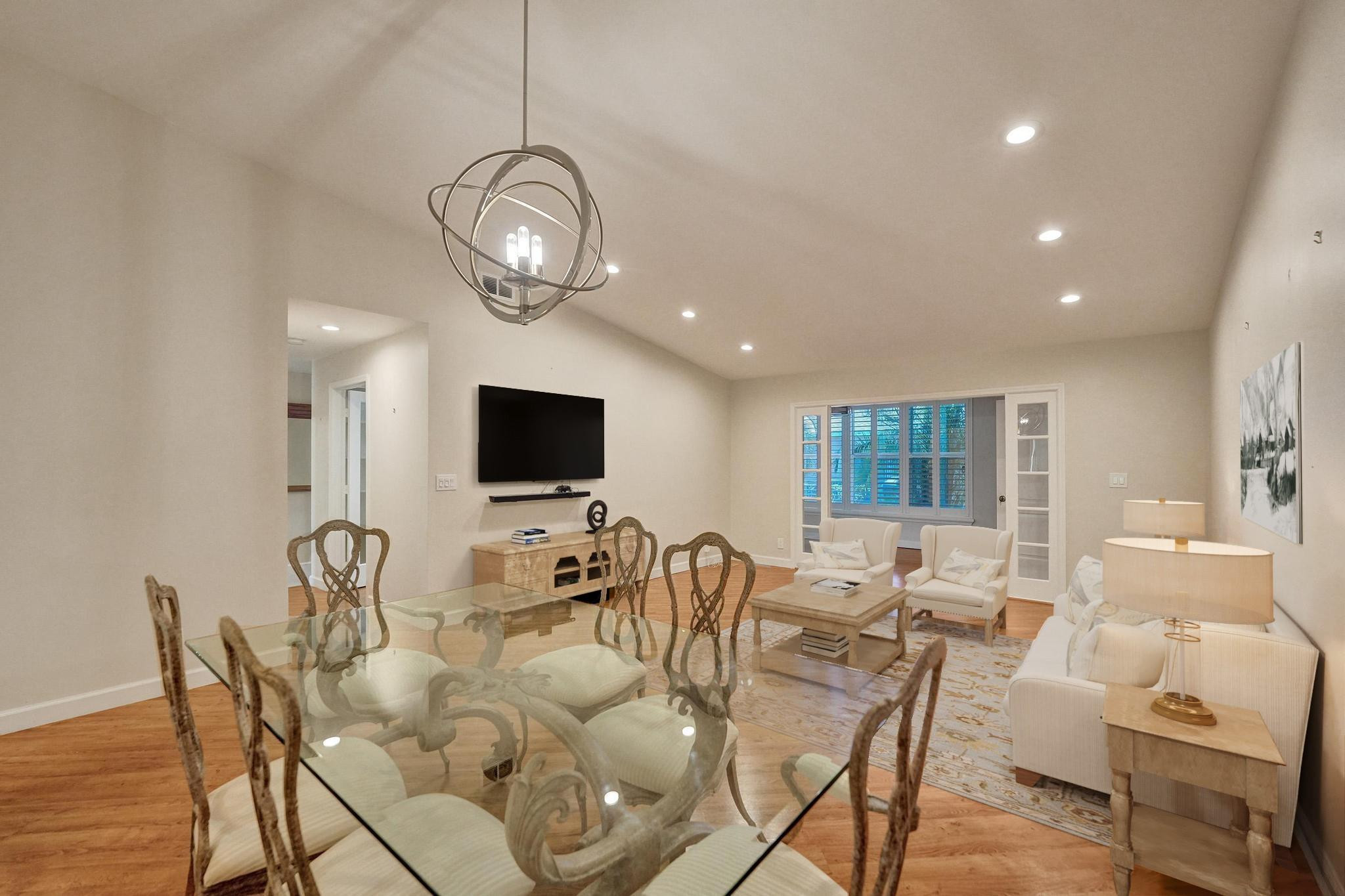 10896 Waterberry Court Boca Raton, FL 33498 - Photo 12 of 34 a view of a dining room with furniture a chandelier and wooden floor