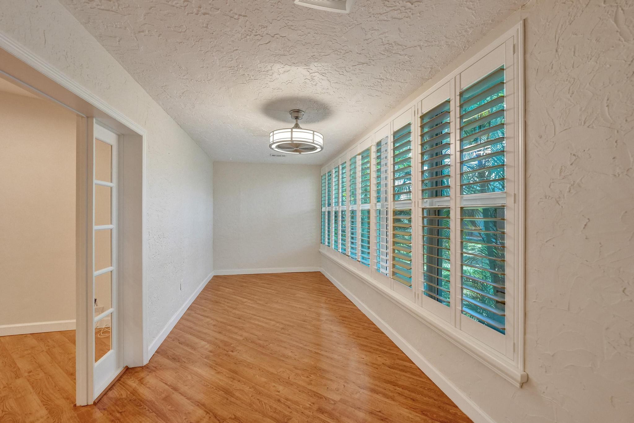 10896 Waterberry Court Boca Raton, FL 33498 - Photo 14 of 34 a view of a room with wooden floor and windows