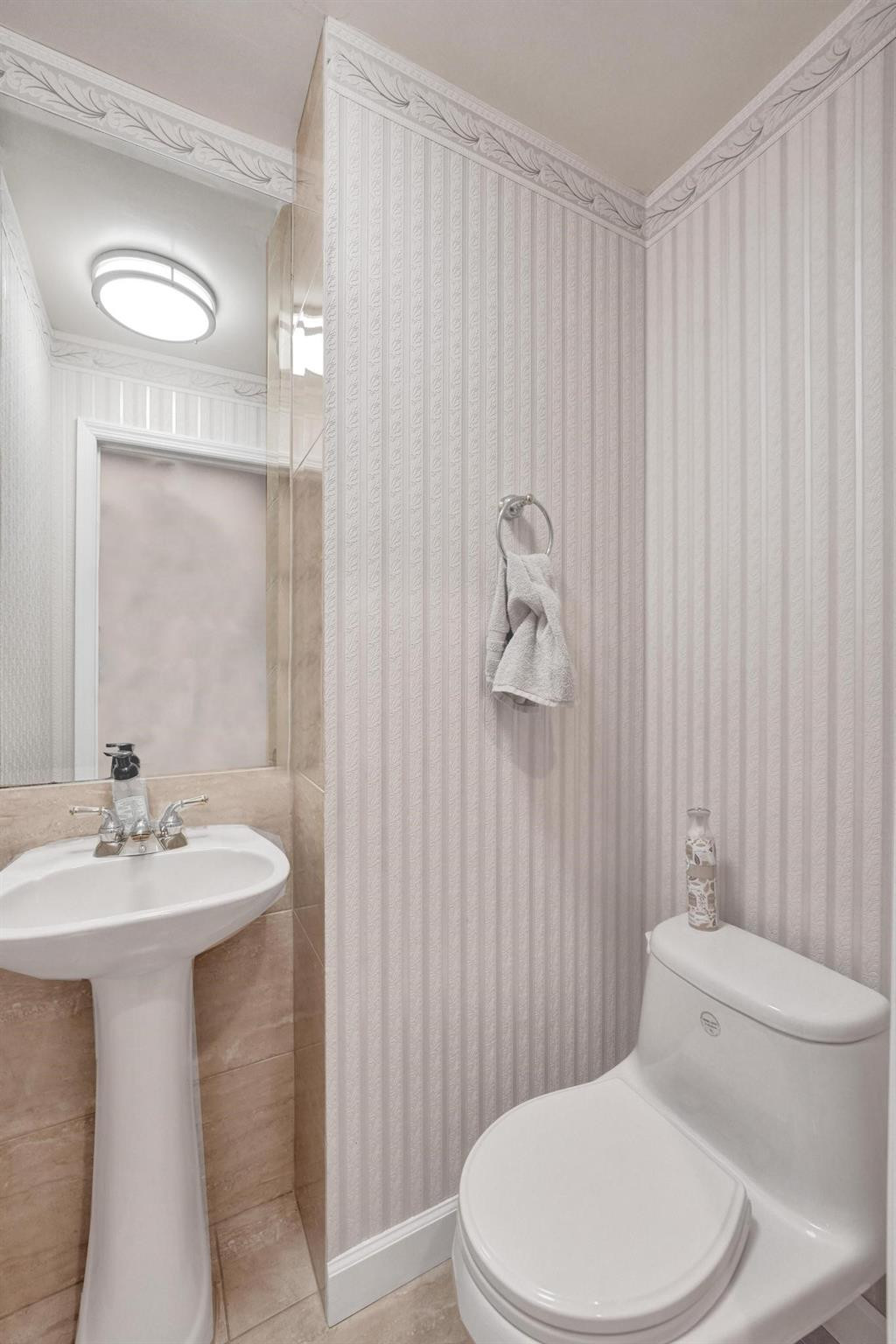 10896 Waterberry Court Boca Raton, FL 33498 - Photo 17 of 34 a white toilet sitting next to a bathroom sink