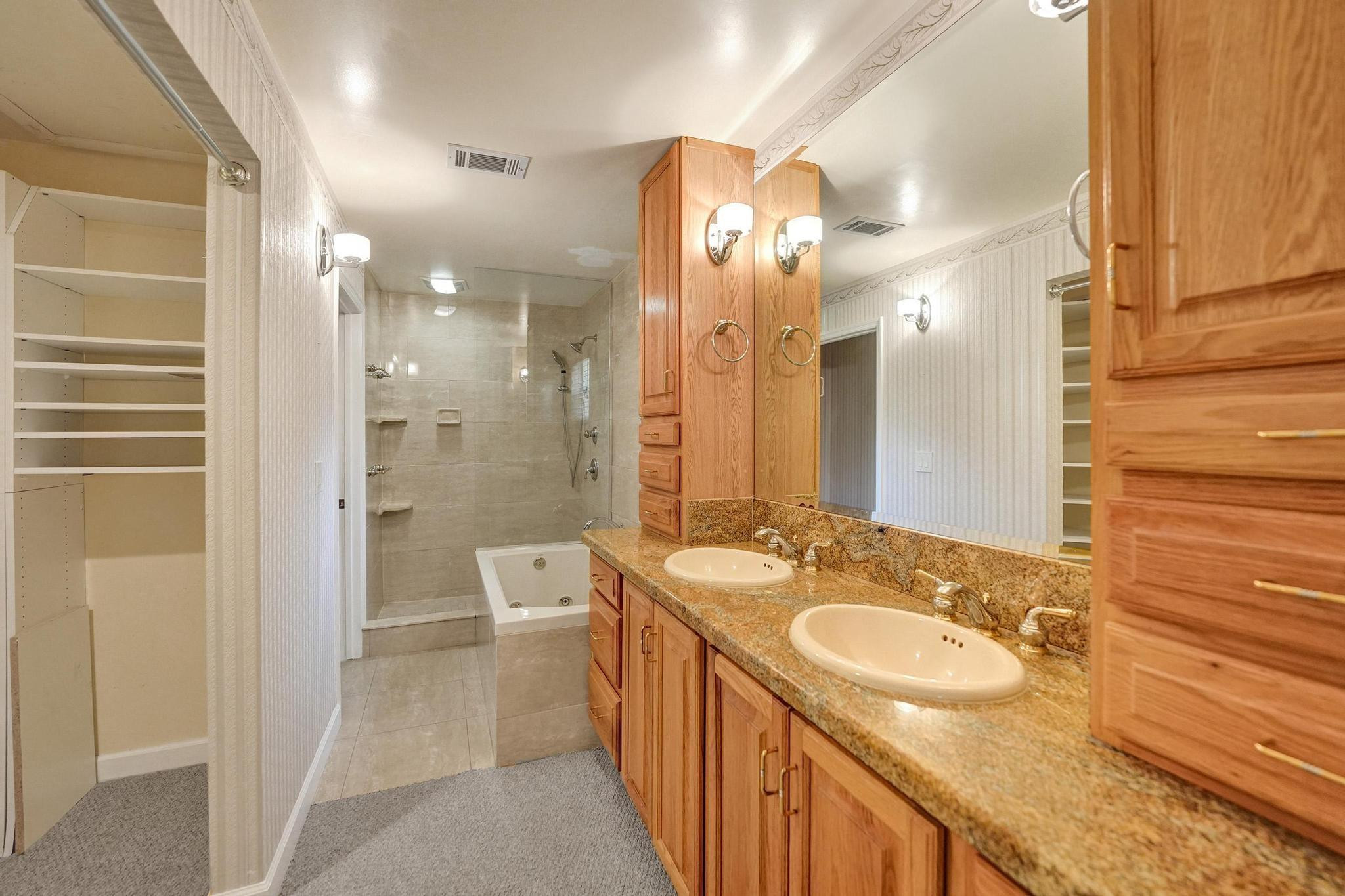 10896 Waterberry Court Boca Raton, FL 33498 - Photo 24 of 34 a bathroom with a granite countertop sink a toilet a shower and a mirror