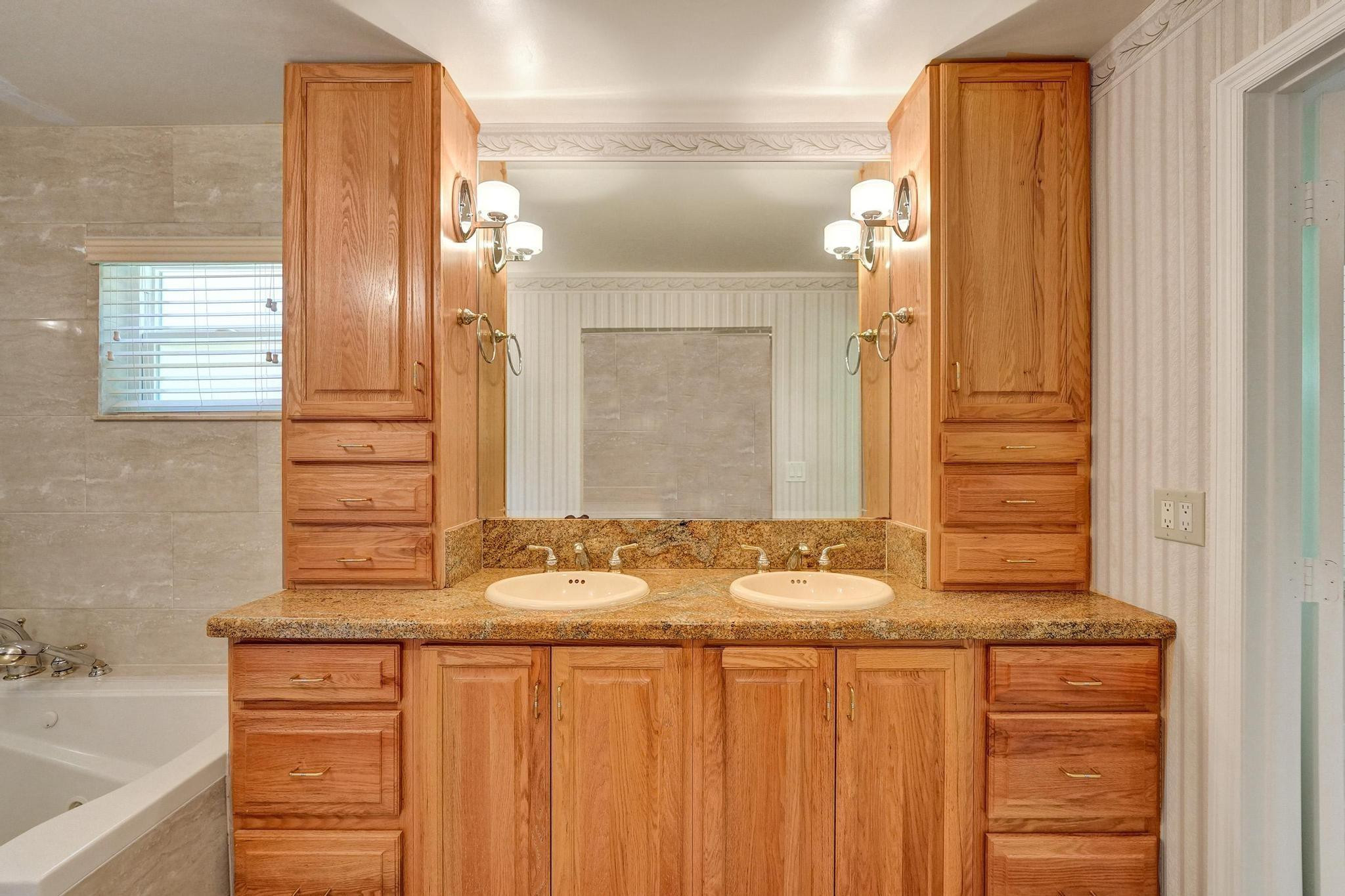10896 Waterberry Court Boca Raton, FL 33498 - Photo 26 of 34 a bathroom with a sink and a mirror