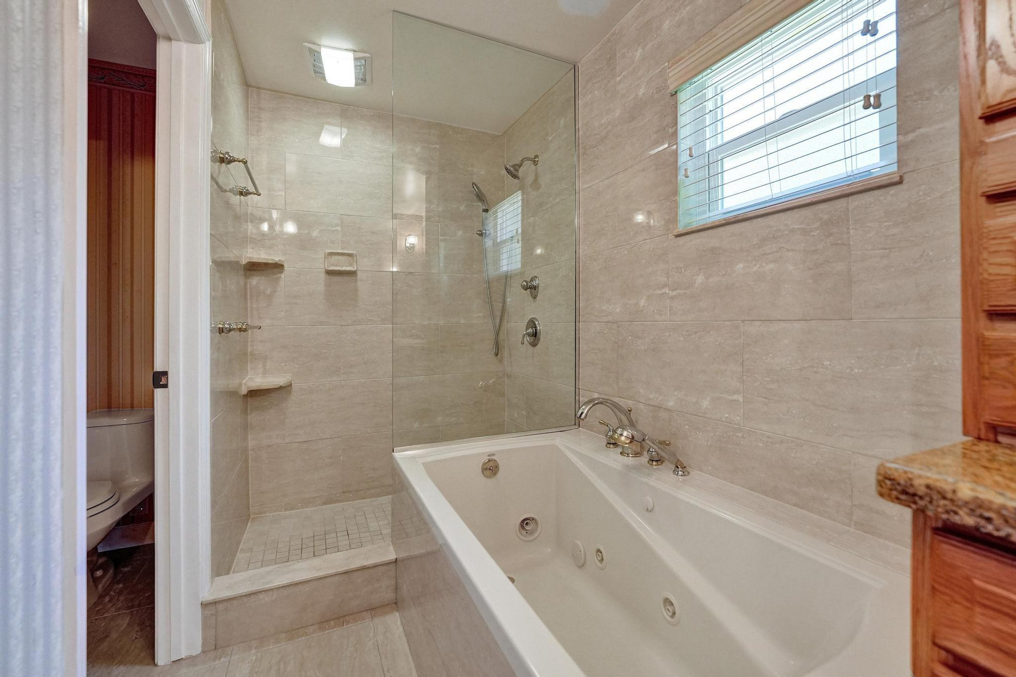 10896 Waterberry Court Boca Raton, FL 33498 - Photo 27 of 34 a bathroom with a tub shower and sink