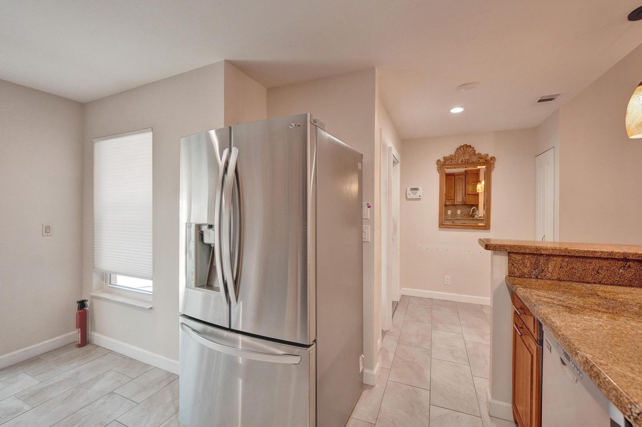 10896 Waterberry Court Boca Raton, FL 33498 - Photo 7 of 34 a kitchen with stainless steel appliances granite countertop a refrigerator and a sink