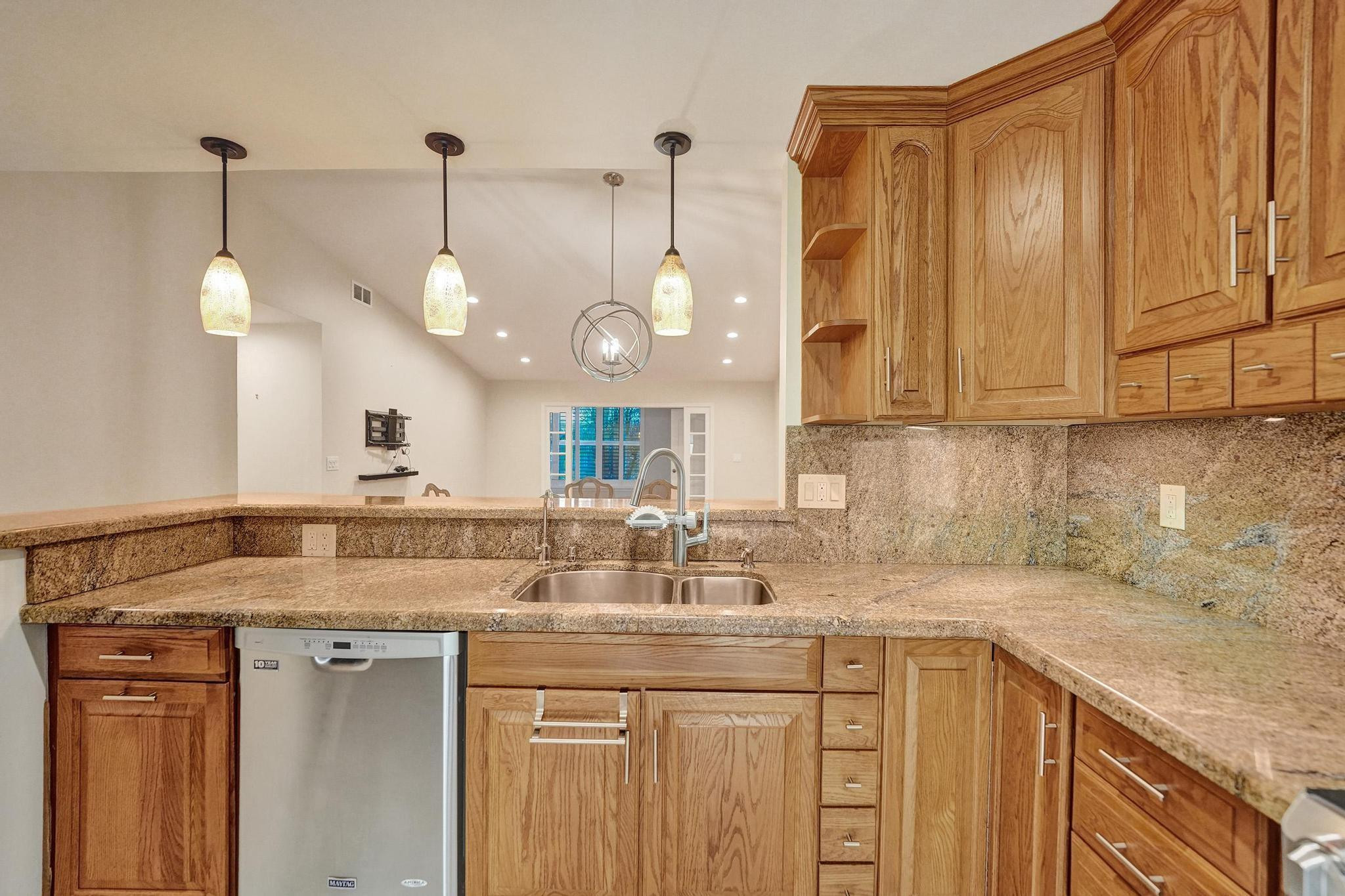 10896 Waterberry Court Boca Raton, FL 33498 - Photo 8 of 34 a kitchen with a sink cabinets and wooden floor