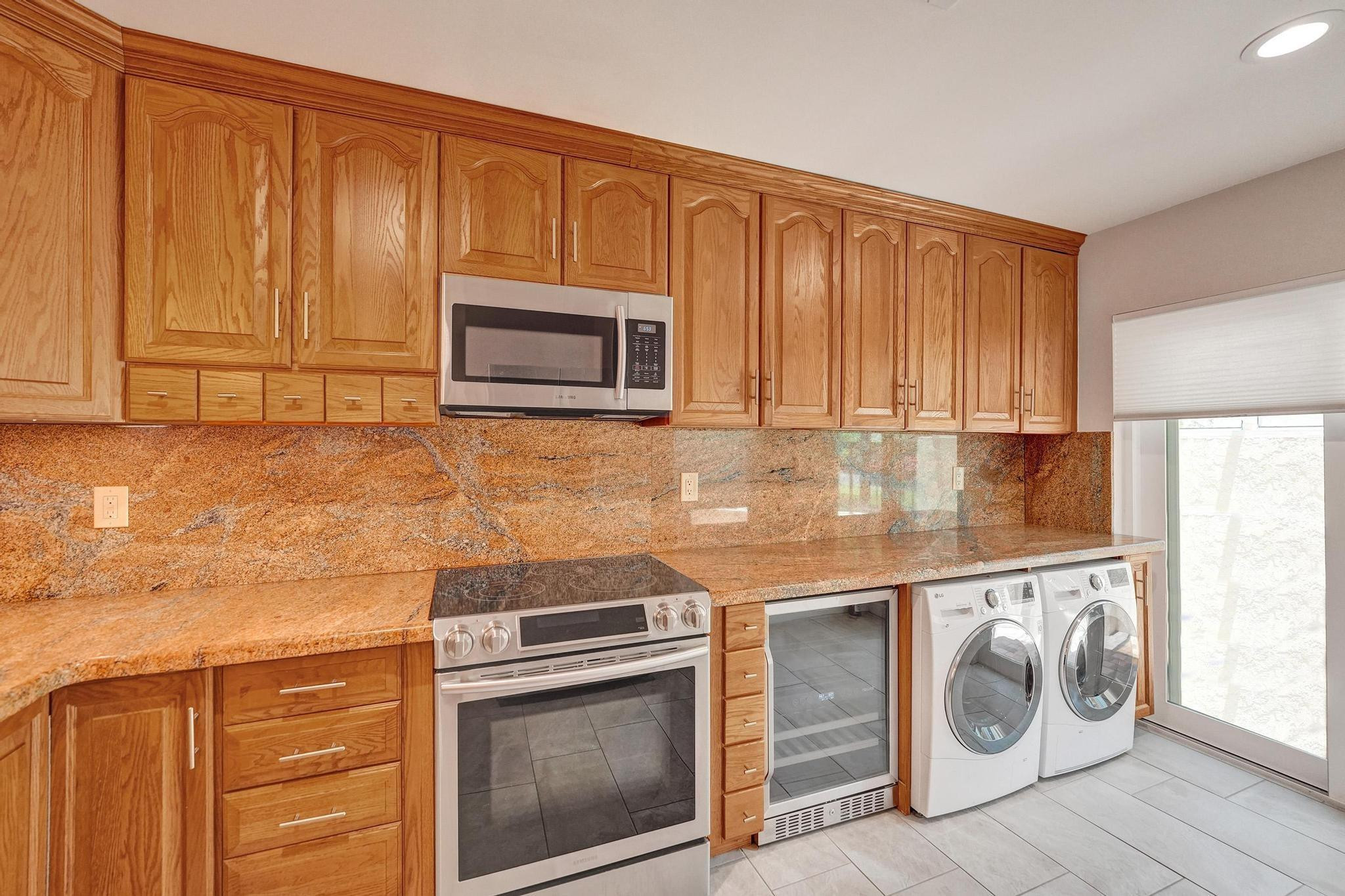 10896 Waterberry Court Boca Raton, FL 33498 - Photo 9 of 34 a kitchen with a stove and a microwave