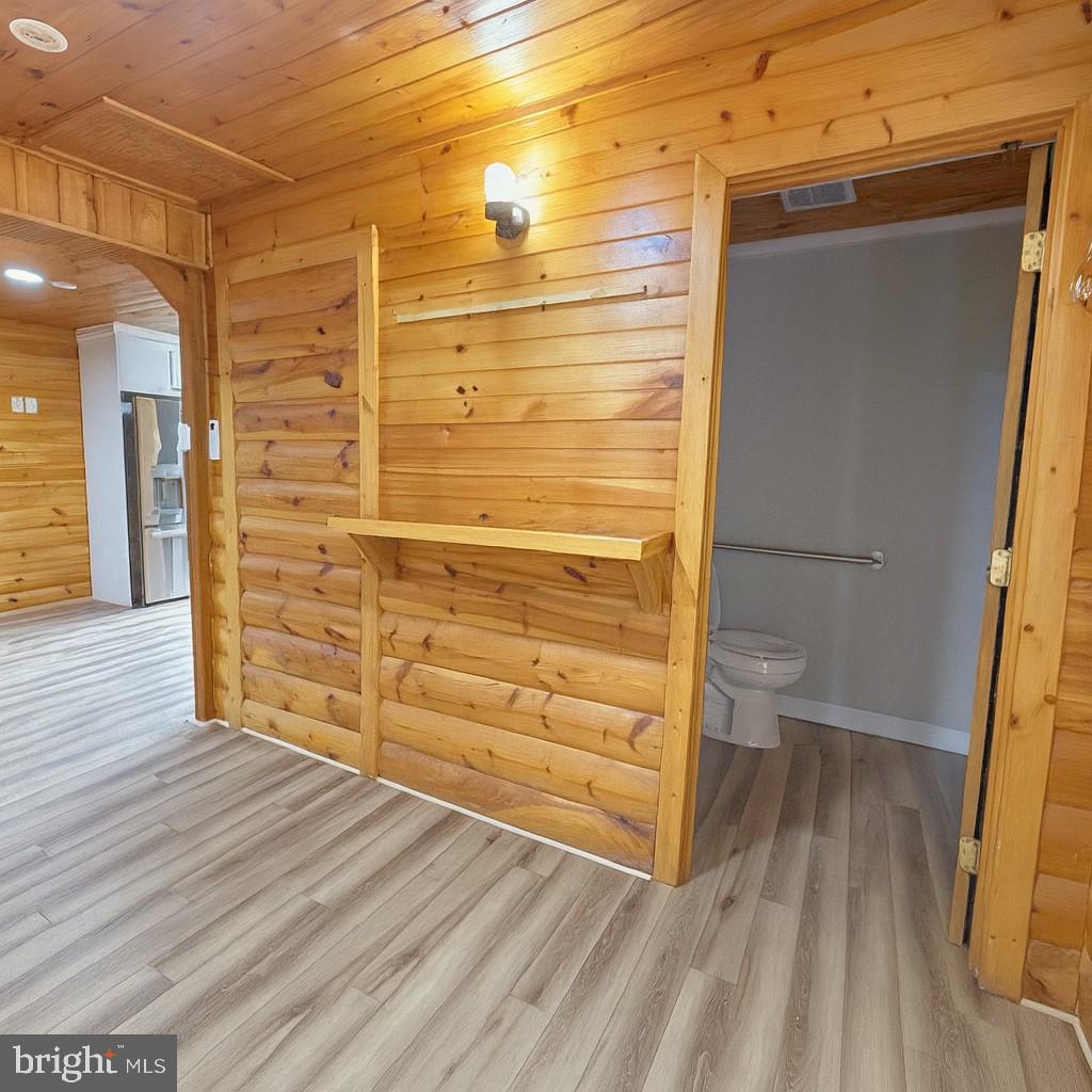7699 Hedgesville Road Hedgesville, WV 25427 - Photo 21 of 47 a view of walk in closet with wooden floor