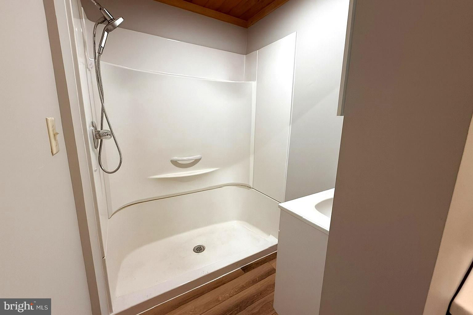 7699 Hedgesville Road Hedgesville, WV 25427 - Photo 26 of 47 a bathroom with a glass shower door