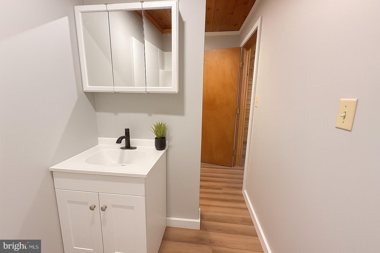 7699 Hedgesville Road Hedgesville, WV 25427 - Photo 27 of 47 a bathroom with a sink and a mirror
