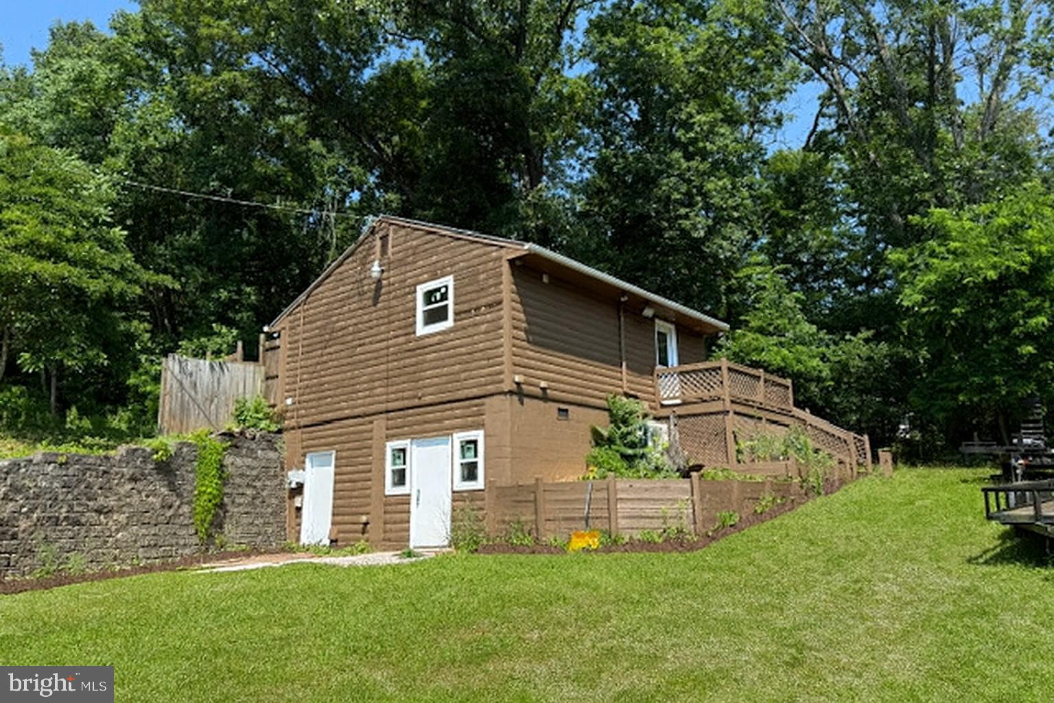 7699 Hedgesville Road Hedgesville, WV 25427 - Photo 3 of 47 a front view of house with a garden