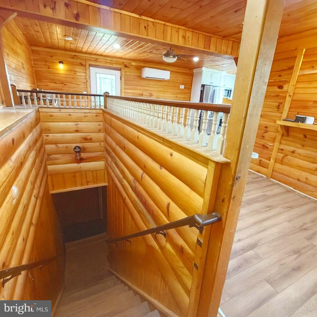 7699 Hedgesville Road Hedgesville, WV 25427 - Photo 33 of 47 a view of an empty room with wooden floor and windows