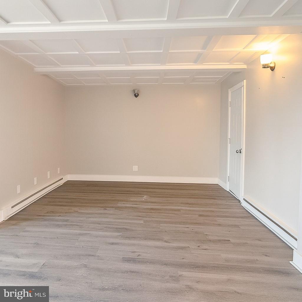 7699 Hedgesville Road Hedgesville, WV 25427 - Photo 40 of 47 a view of an empty room with wooden floor and a window