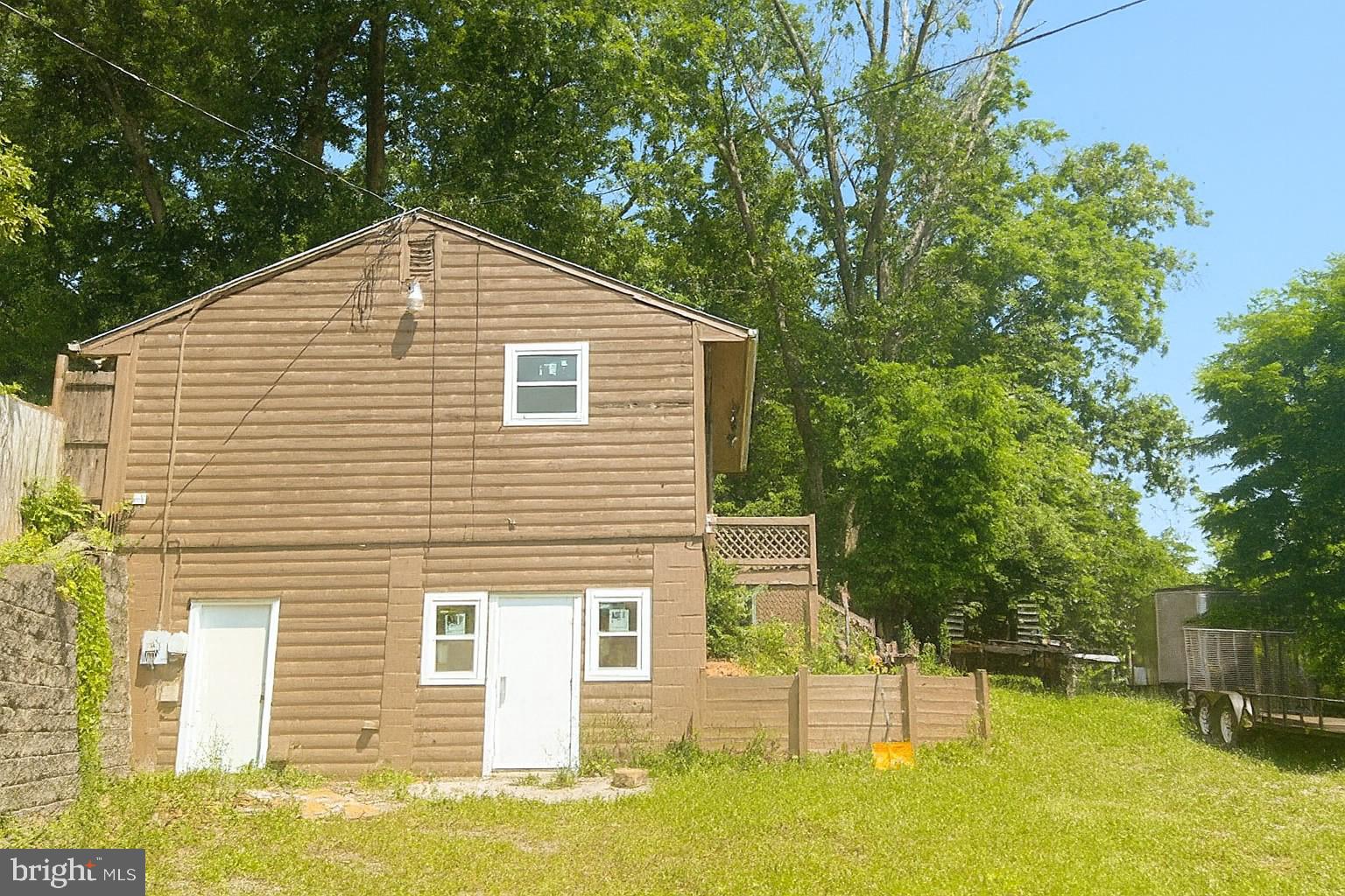 7699 Hedgesville Road Hedgesville, WV 25427 - Photo 4 of 47 a front view of a house with a yard