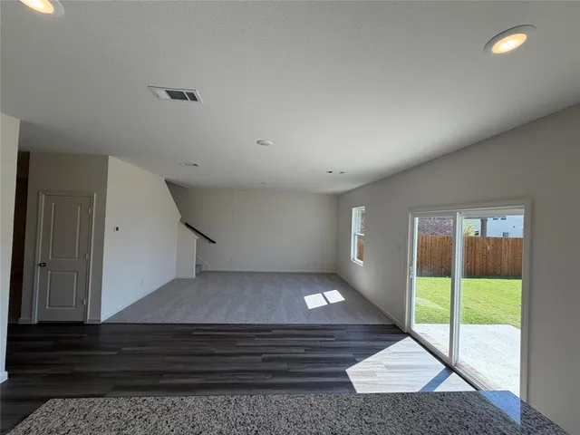 a view of kitchen with wooden floor and electronic appliances