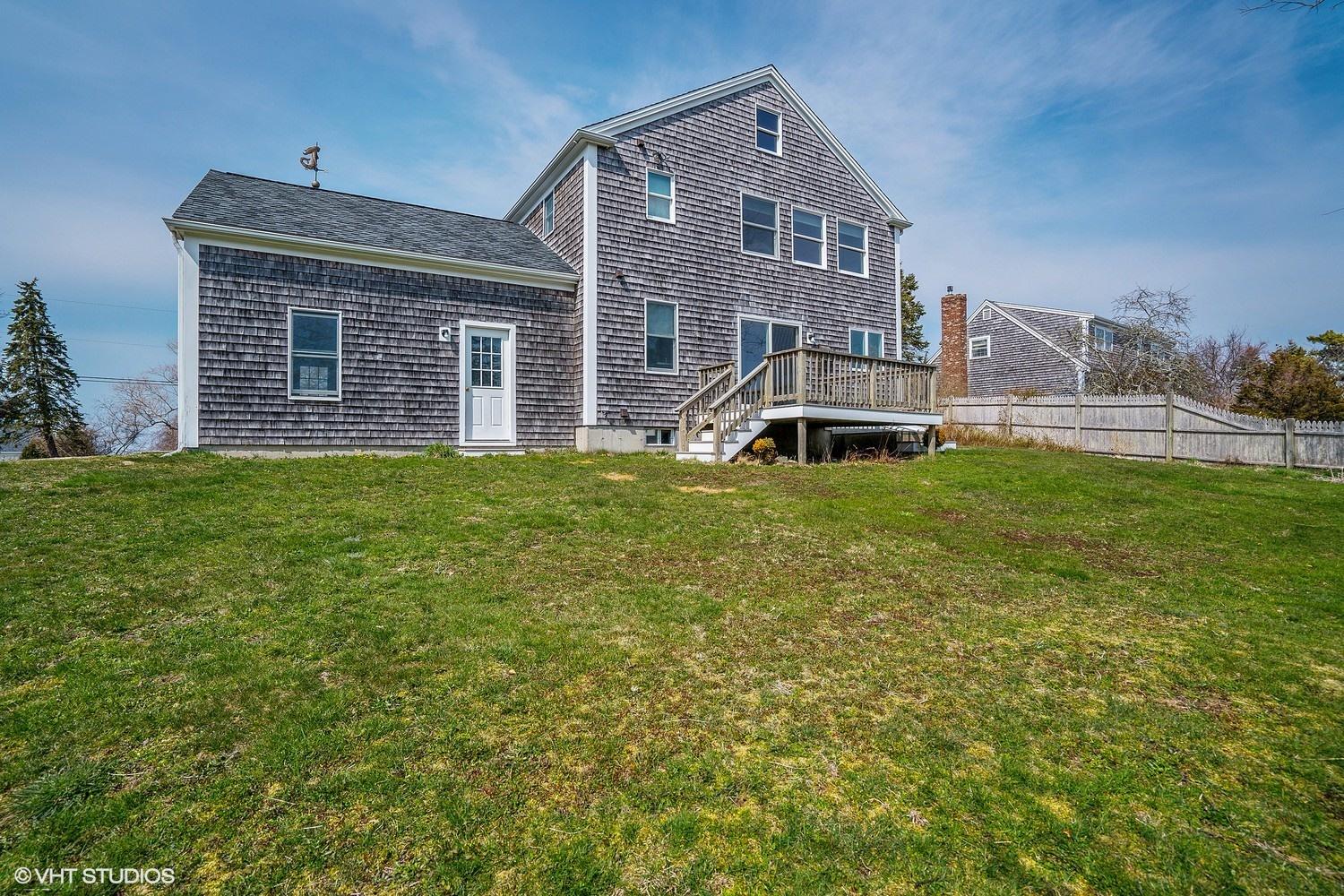 151 Harbor Point Road Cummaquid, MA 02675 - Photo 12 of 14 a view of a house with a yard