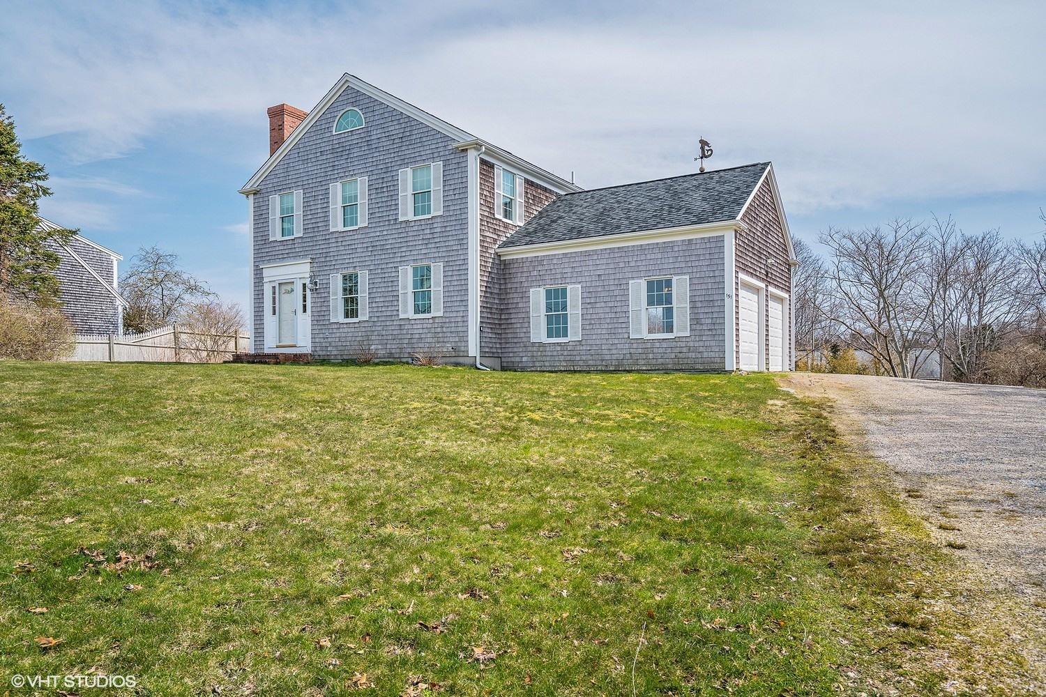 151 Harbor Point Road Cummaquid, MA 02675 - Photo 3 of 14 a house that is sitting in the grass with large windows