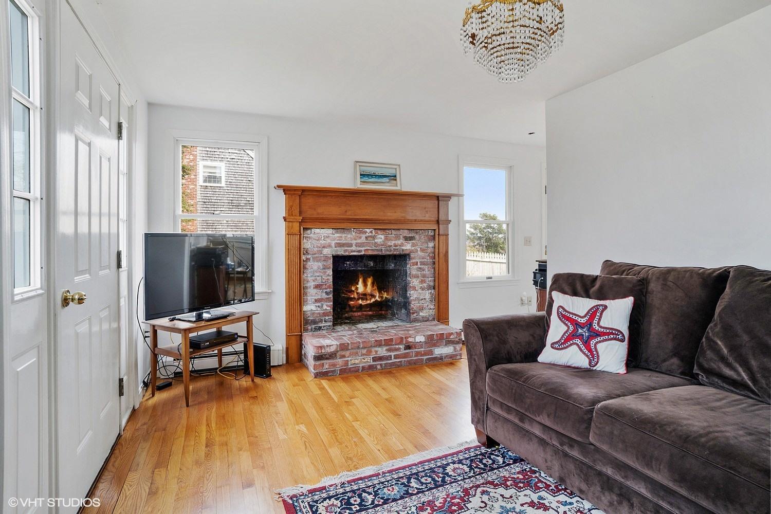 151 Harbor Point Road Cummaquid, MA 02675 - Photo 6 of 14 a living room with furniture and a fireplace