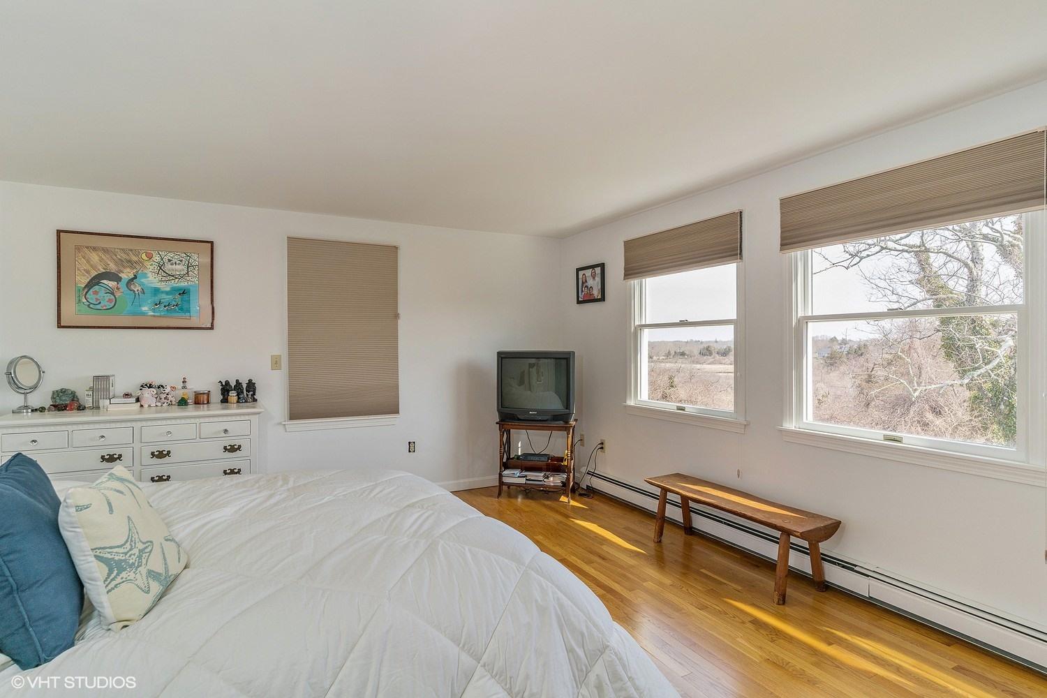 151 Harbor Point Road Cummaquid, MA 02675 - Photo 10 of 14 a spacious bedroom with a bed and a window