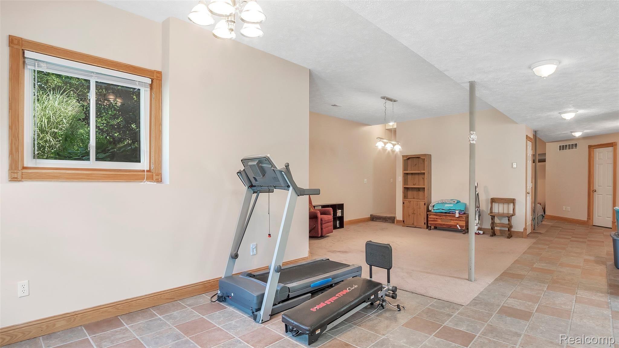 6063 Rivers Edge Drive Howell, MI 48855 - Photo 25 of 39 Ceramic flooring, carpet and door at far end is mechanicals room.
