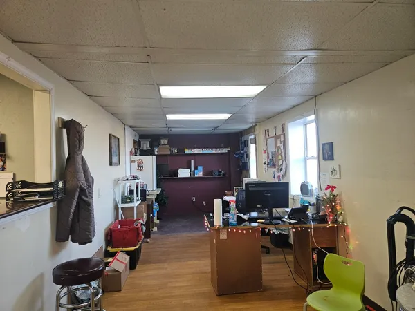 a room with water heater and wooden floor
