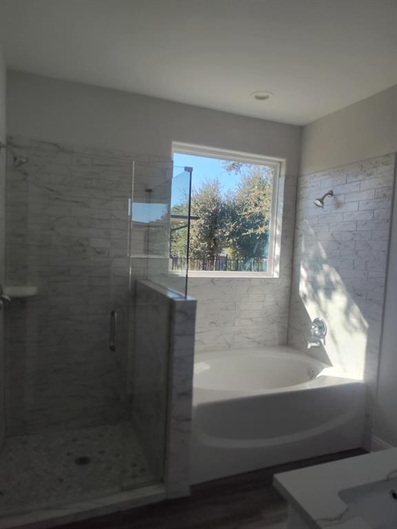 20008 Boggy Ford Road Lago Vista, TX 78645 - Photo 7 of 17 Full bath featuring a shower stall, a bath, and vanity
