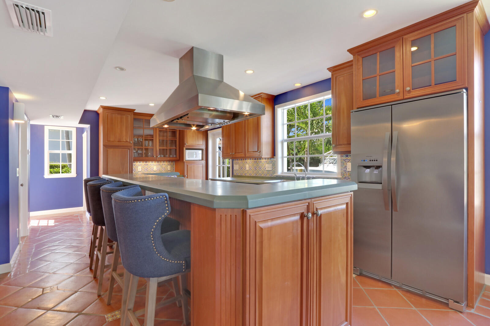 1210 Bimini Lane Singer Island, FL 33404 - Photo 23 of 64 a kitchen with stainless steel appliances granite countertop a refrigerator a sink a dining table and chairs