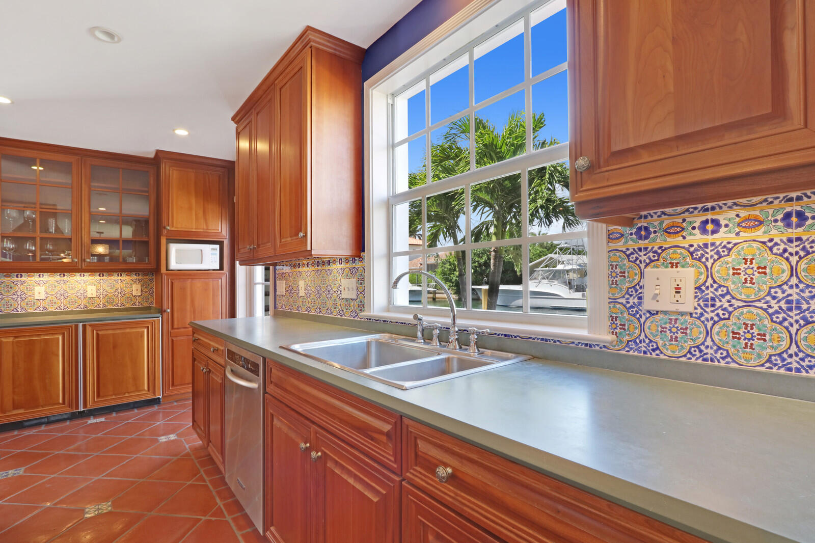 1210 Bimini Lane Singer Island, FL 33404 - Photo 27 of 64 a kitchen with stainless steel appliances granite countertop a sink a counter space and a window