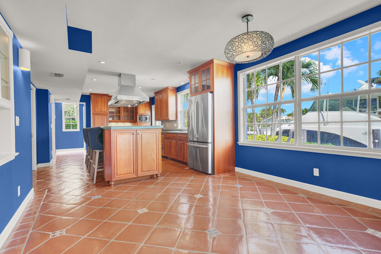 1210 Bimini Lane Singer Island, FL 33404 - Photo 32 of 64 a view of a kitchen with fridge and windows