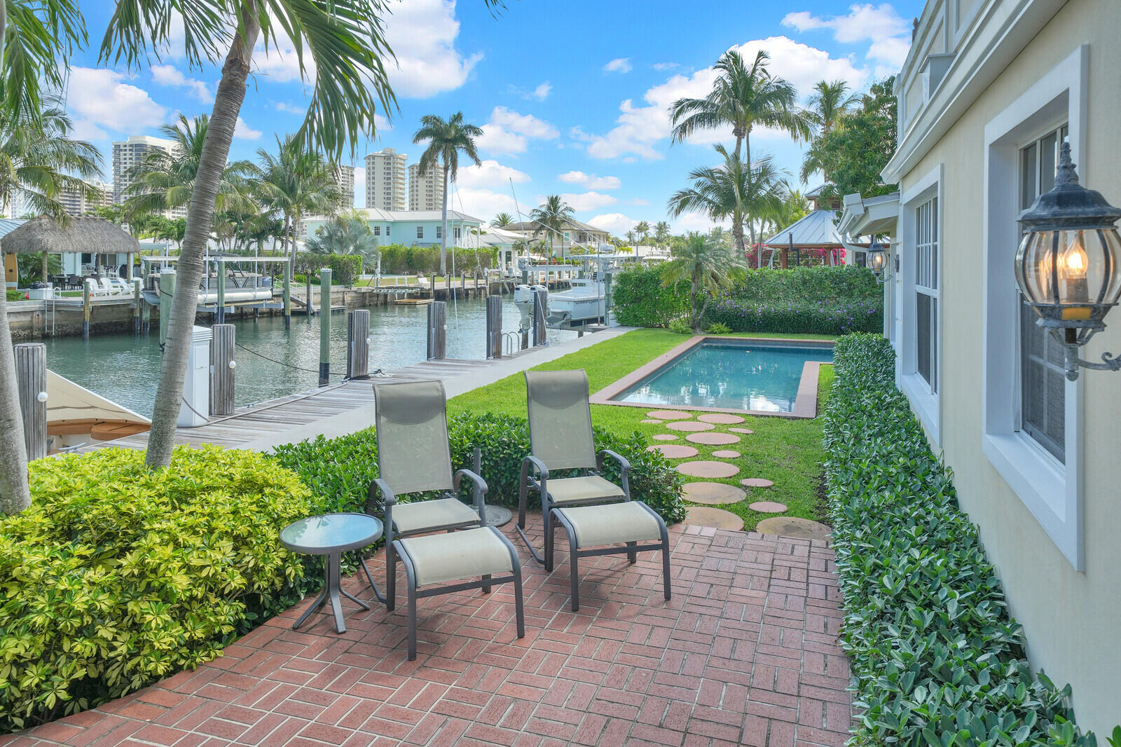 1210 Bimini Lane Singer Island, FL 33404 - Photo 49 of 64 a view of a chair and tables in the patio next to a yard
