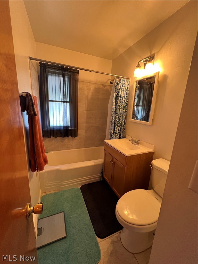 3892 East 189th Street Cleveland, OH 44122 - Photo 7 of 16 Full bathroom with tile floors, vanity, toilet, and shower / tub combo with curtain